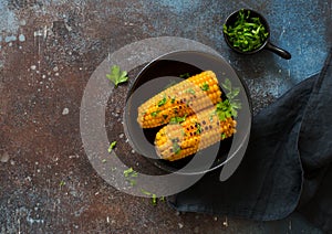Grilled swet corn in a black bowl