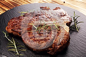 Grilled T-bone steak on stone cutting board