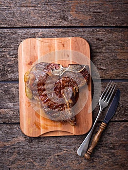 Grilled T-bone steak on wooden board