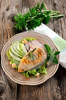 Grilled tasty chicken breast with avocado