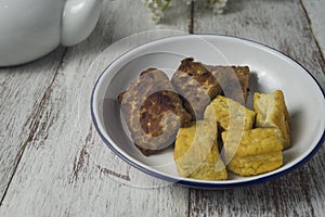 Grilled tempe and tofu on white plate