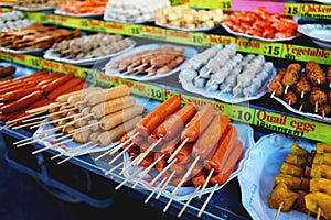Grilled Thai sausages, fishballs and seafood on the stove at Traditional Market, Thailand