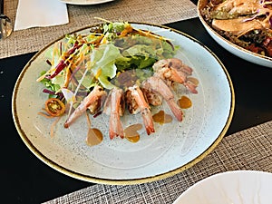 Grilled tiger prawns served with organic vegetable salad.