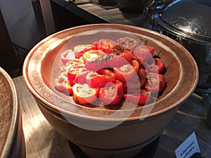 Grilled tomato presentation in hotel breakfast buffet.
