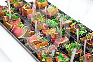 Grilled tuna chunks served with fresh green herbs