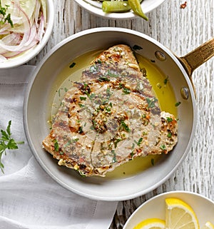 Grilled tuna steak in herb and lemon marinade