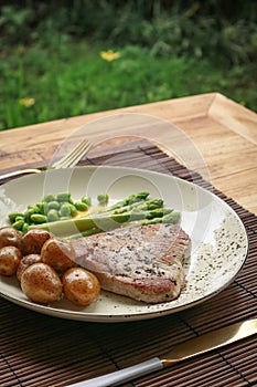 Grilled tuna steak served with asparagus