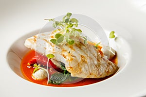 Grilled turbot, tabouli, sweet pepper sauce and summer vegetables. White dish