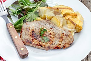 Grilled turkey cutlet and potato gratin