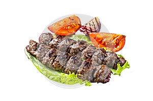 Grilled Urfa kebab with tomato, salad and onion. Isolated, white background.