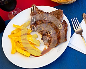 Grilled veal meat with potatoes. Churrasco de ternera. photo