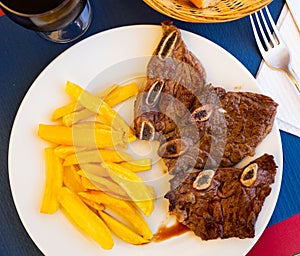 Grilled veal meat with potatoes. Churrasco de ternera. Spanish cuisine photo