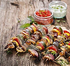 Grilled vegetable and meat skewers on a wooden rustic table