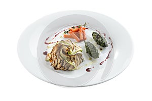 Grilled vegetables eggplant, zucchini, baby carrot and spinach on white plate isolated on white background