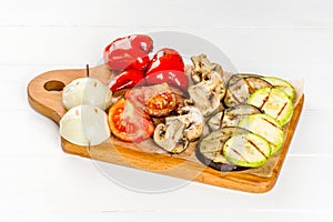 Grilled vegetables filmed on a wooden board close-up