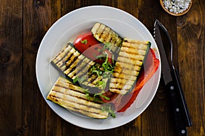 Grilled vegetables on plate on wooden