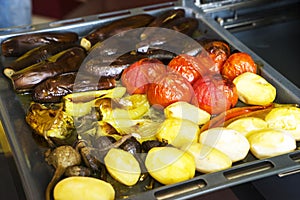Grilled vegetables, roasted slices of potatoes, eggplants and zucchini, vegetarian and vegan dish, close up