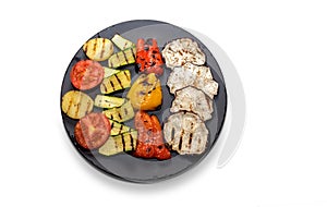 Grilled vegetables on round black plate