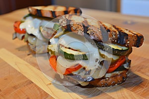 grilled veggie sandwich with melted cheese oozing