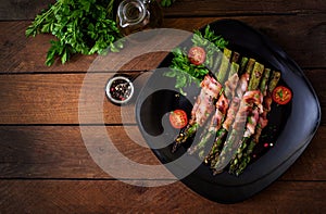 Grilled violet asparagus wrapped with bacon.