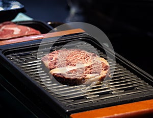 Grilled wagyu beef, Raw marble beef steak frying in black grill