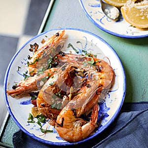 Grilled whole pink prawns seasoned with herbs photo