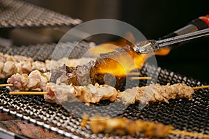 Grilled yakitori chicken skewers at an Izakaya restaurant in Omoide Yokocho street in the Shinjuku district of Tokyo.