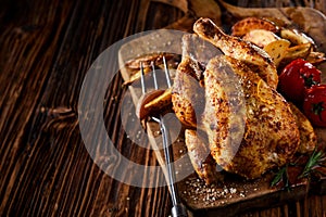 Grilled young poussin or spring chicken photo