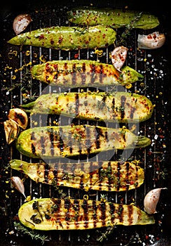 Grilled zucchini with addition of thyme, lemon zest and garlic