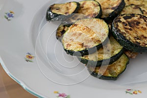 Grilled zuchini courgette served on decorated plate