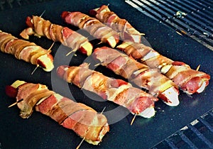 Grilling Bacon-Wrapped Cheese Dogs photo