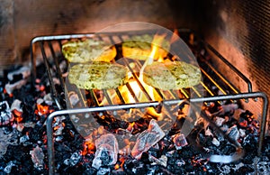 Grilling barbecue cheese over hot coals, fire and flame.