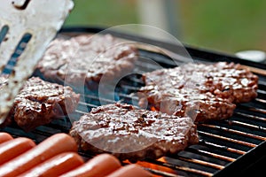 Grilling burgers and hot dogs photo