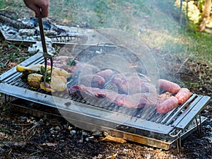 slow grilling chorizo sausages , chicken quarters, skirt and flank muscle steaks argentinian cuts photo