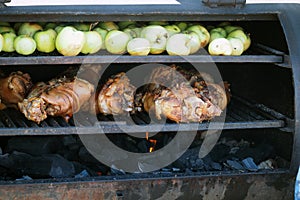 Grilling food. The meat is barbecued with coals. Pork knuckle with apples on the barbecue. High quality photo