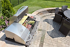 Grilling food on an outdoor gas barbecue photo
