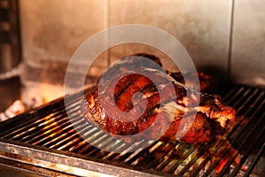 Grilling grate with pork foreshanks in oven