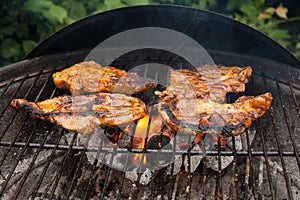 Grilling a juicy steak in the flames of a coal barbecue