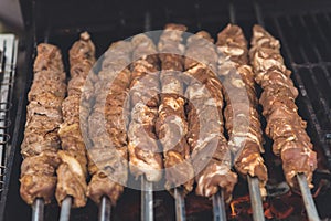 Grilling marinated shashlik on a grill.