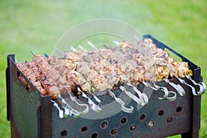 Grilling marinated shashlik on a grill.