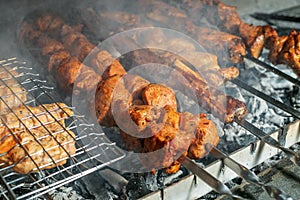 Grilling marinated shashlik on a grill. Shashlik is a form of Shish kebab