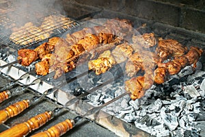 Grilling marinated shashlik on a grill. Shashlik is a form of Shish kebab