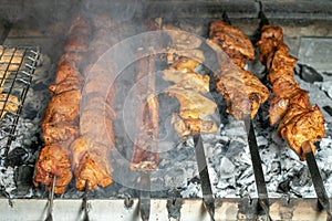 Grilling marinated shashlik on a grill. Shashlik is a form of Shish kebab