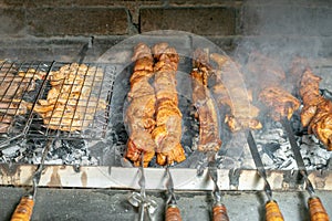 Grilling marinated shashlik on a grill. Shashlik is a form of Shish kebab
