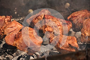 Grilling marinated shashlik on a grill. Shashlik is a form of Shish kebab popular in Eastern, Central Europe