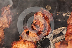 Grilling marinated shashlik on a grill. Shashlik is a form of Shish kebab popular in Eastern, Central Europe