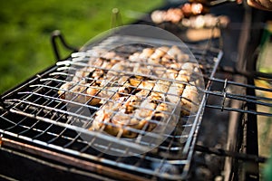 Grilling marinated shashlik on a grill. Shashlik is a form of Shish kebab popular in Eastern, Central Europe and other places.