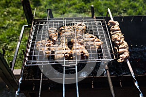Grilling marinated shashlik on a grill. Shashlik is a form of Shish kebab popular in Eastern, Central Europe and other places.