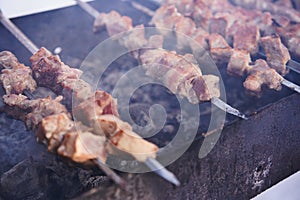 Grilling marinated shashlik on a grill. Shashlik is a form of Shish kebab popular in Europe and other places