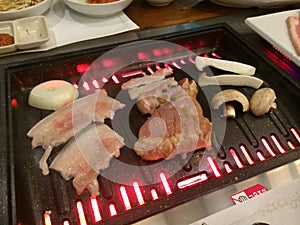 Grilling meat in Korean Style BBQ